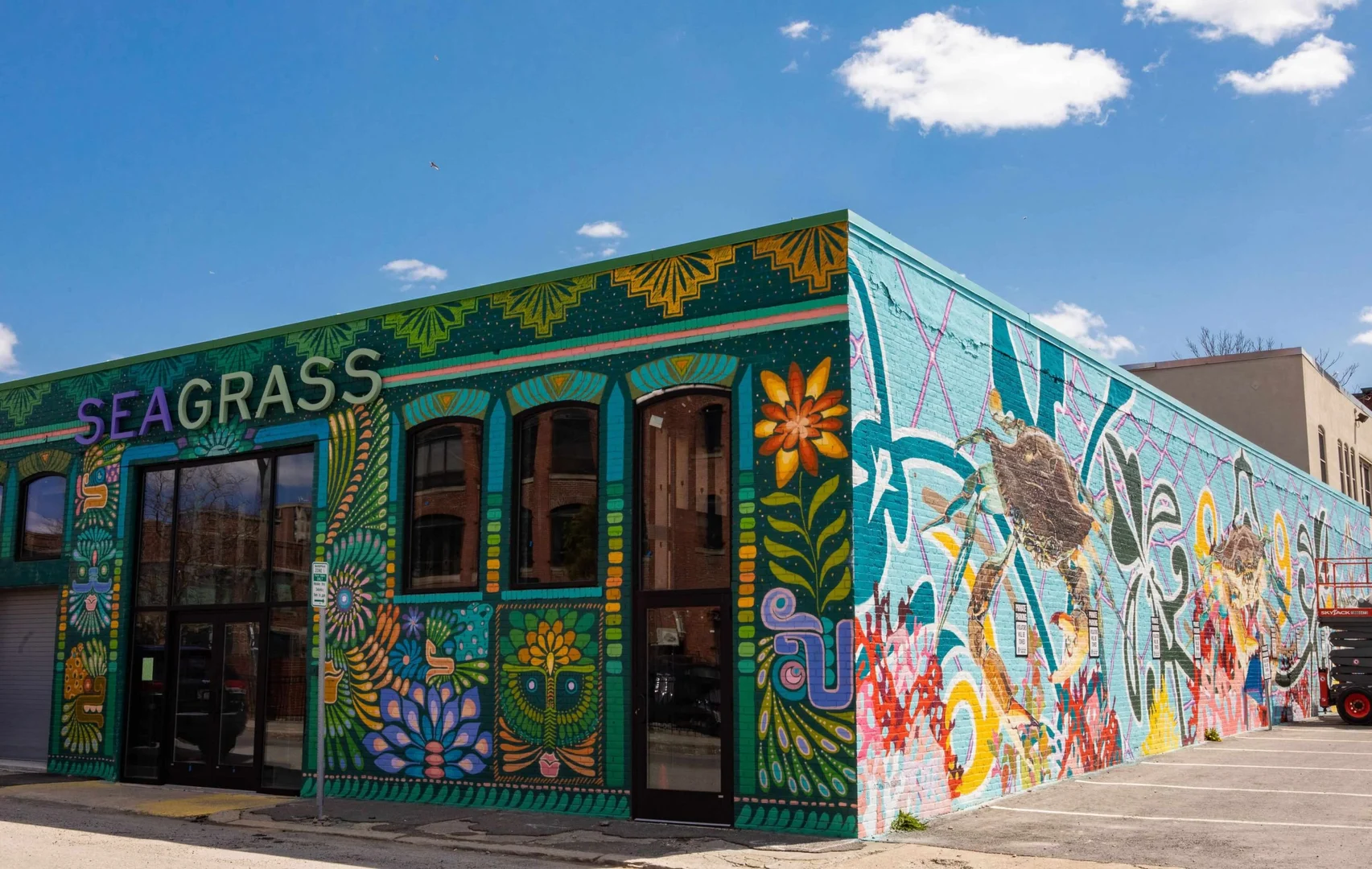 The Seagrass storefront on Dodge Street, its exterior painted with a mural